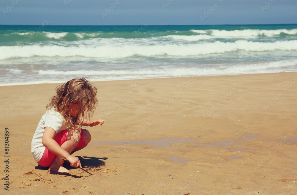 cute happy kid (girl) playing at the beach cute happy kid (girl) playing at the beach