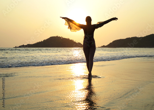 Young woman meditating on Palolem beach. South Goa  India