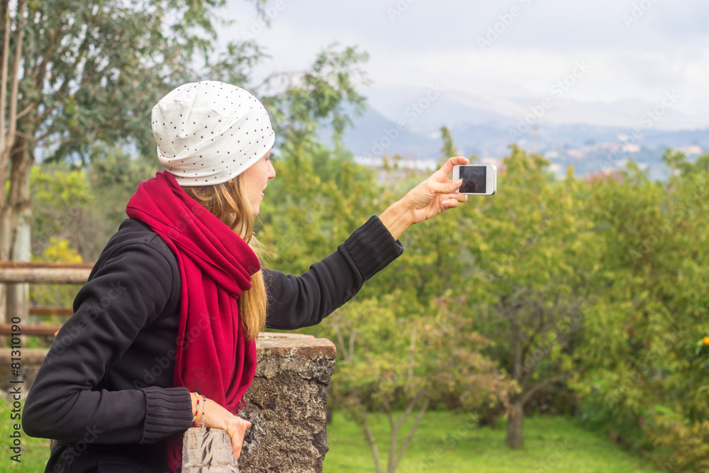 Woman taking mobile photo of nature landscape Woman taking mobile photo of nature landscape