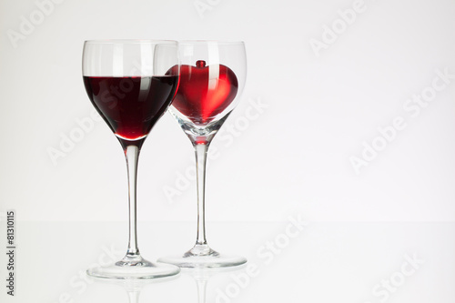 Wine glasses with red wine and heart