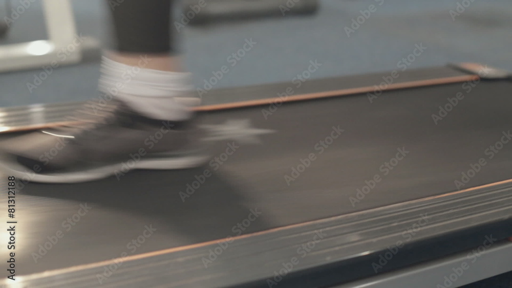 Close-up of a girl walking on a treadmill