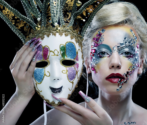 woman with artistic make-up holding mask
