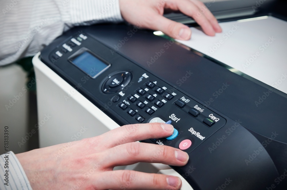 Man using scanner multifunction device in office Man using scanner multifunction device in office