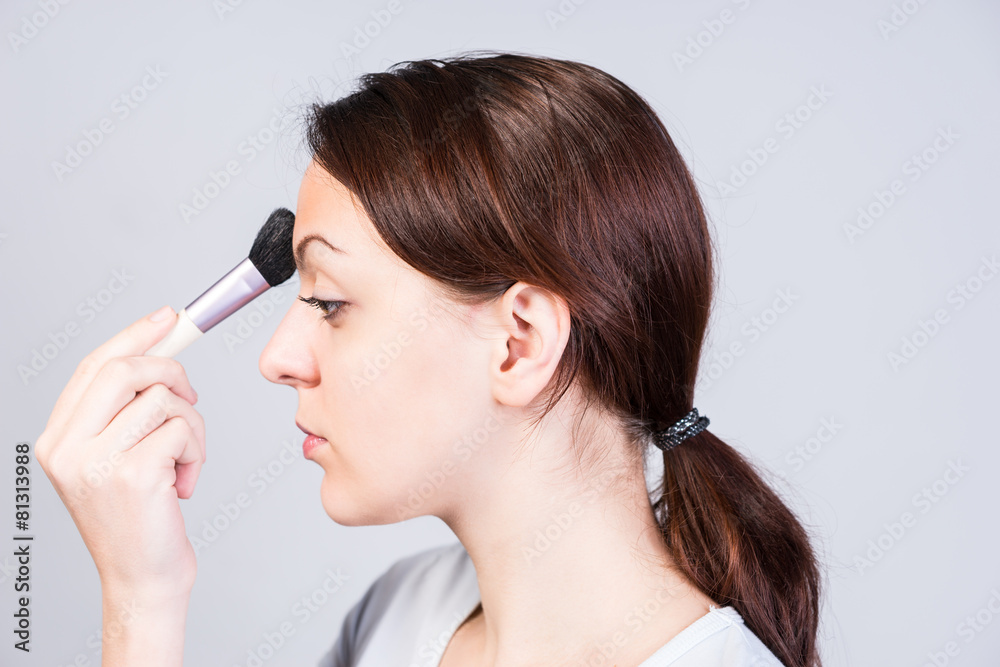 Woman in Side View Applying Makeup on Forehead Woman in Side View Applying Makeup on Forehead