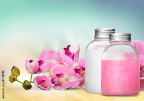 Cosmetics. Pink soap bottles and flowers