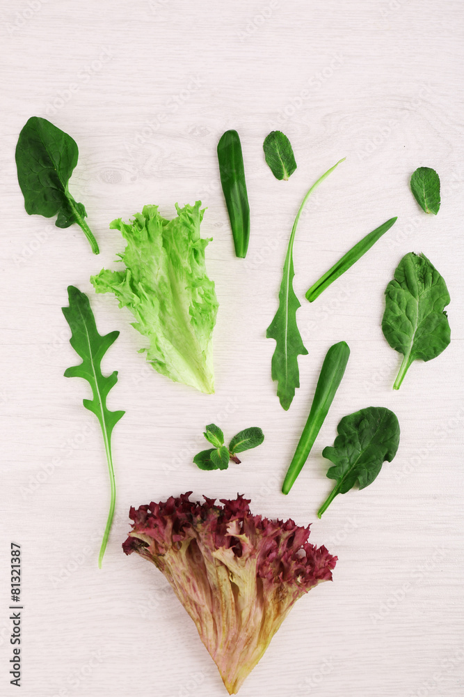 Variety of green leaves for salad, on wooden table - obrazy, fototapety, plakaty 