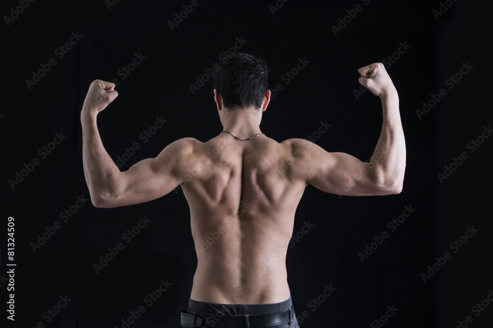 Back of shirtless muscular young man doing double biceps pose