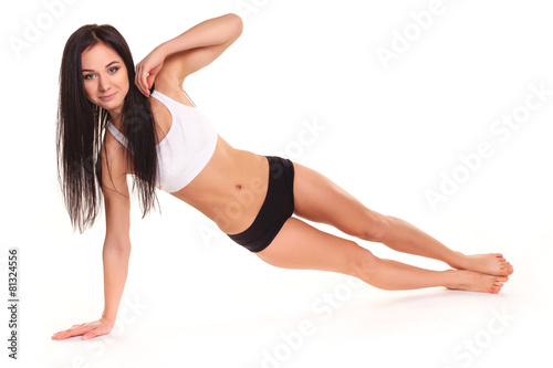 Beautiful young woman exercising in a fitness center - Pushup
