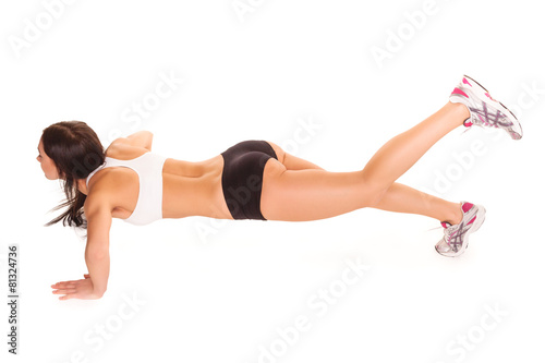 Beautiful young woman exercising in a fitness center - Pushup