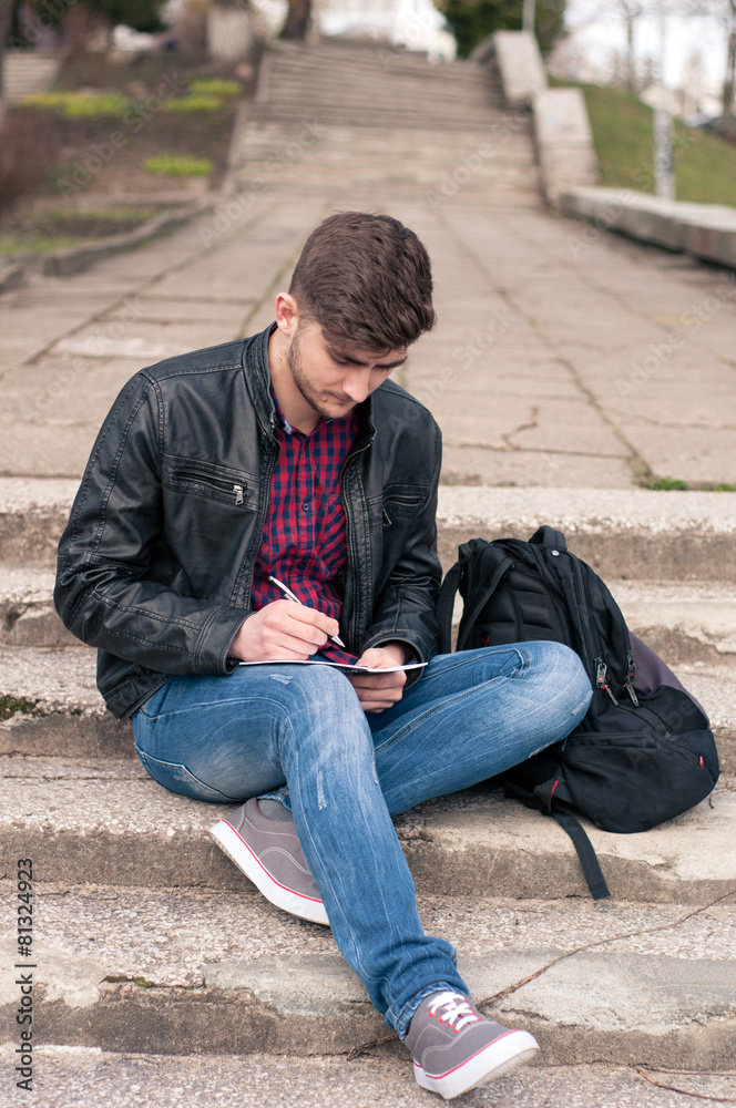 Businessman writing on notebook and planning his day