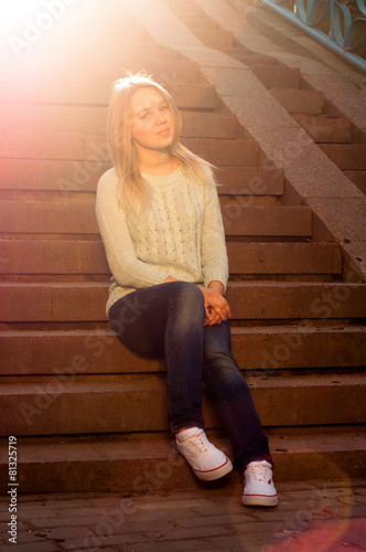 The girl with the sun in her hair sitting on stairs, toned © photoguns