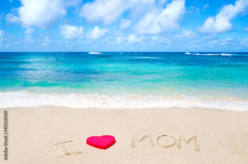 Sign "I love mom" on the beach