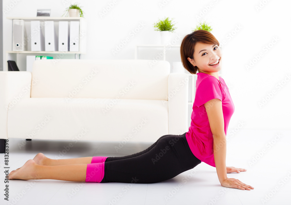 beautiful young woman stretching on the floor beautiful young woman stretching on the floor