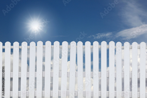 White fence on a blue sky.
