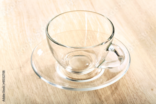 transparent glass cup and saucer close-up on wooden table