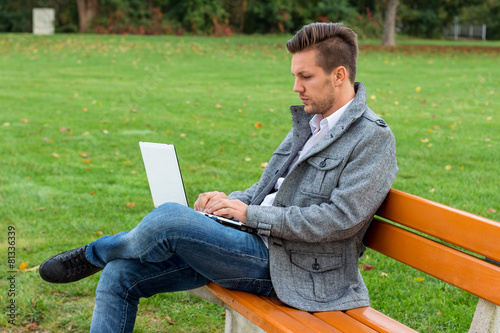 Mann mit Laptop im Park photo