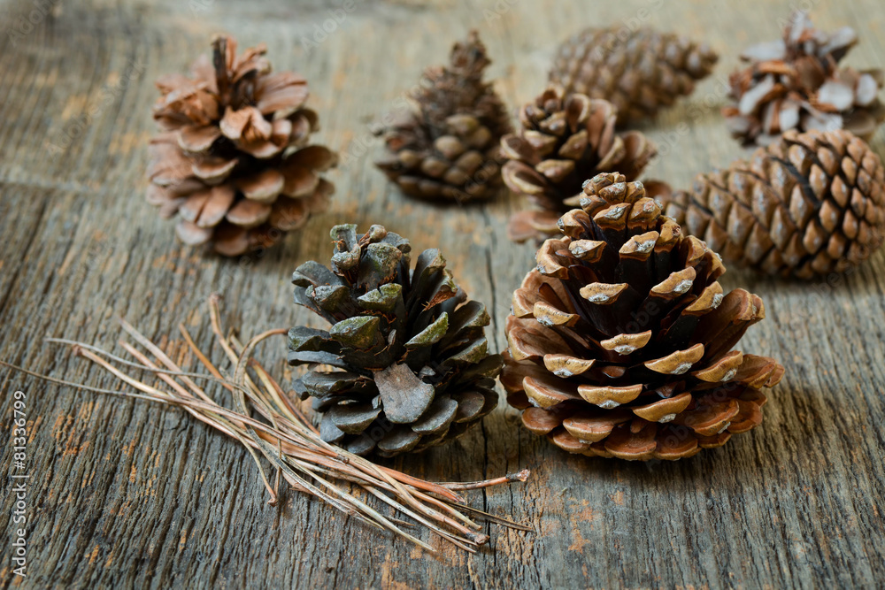 Isolated fir cones with wooden background Isolated fir cones with wooden background