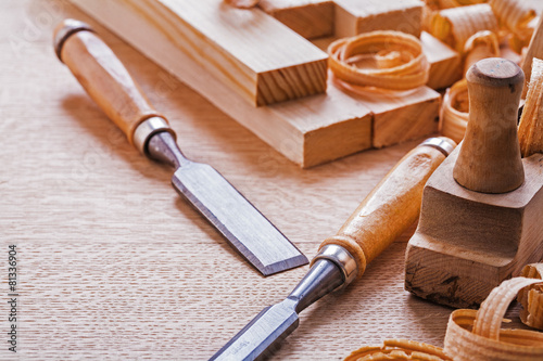 chisels plane planks shavings on wooden board