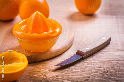 squeezer orange knife on wooden desk
