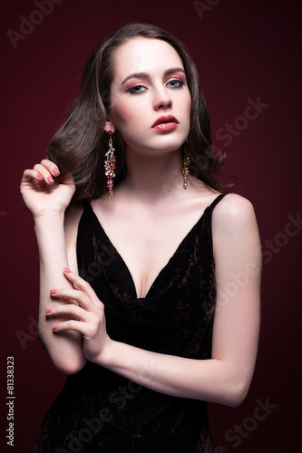 Young beautiful woman in black dress with green pistachio colour