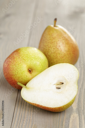 three ripe pears  on wood table