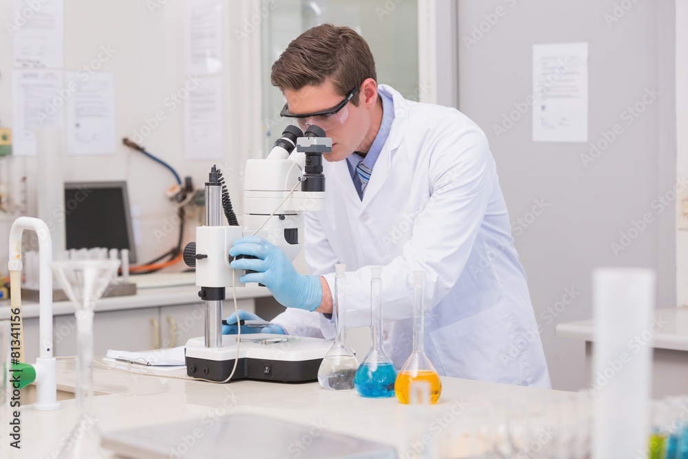 Scientist looking through a microscope Scientist looking through a microscope