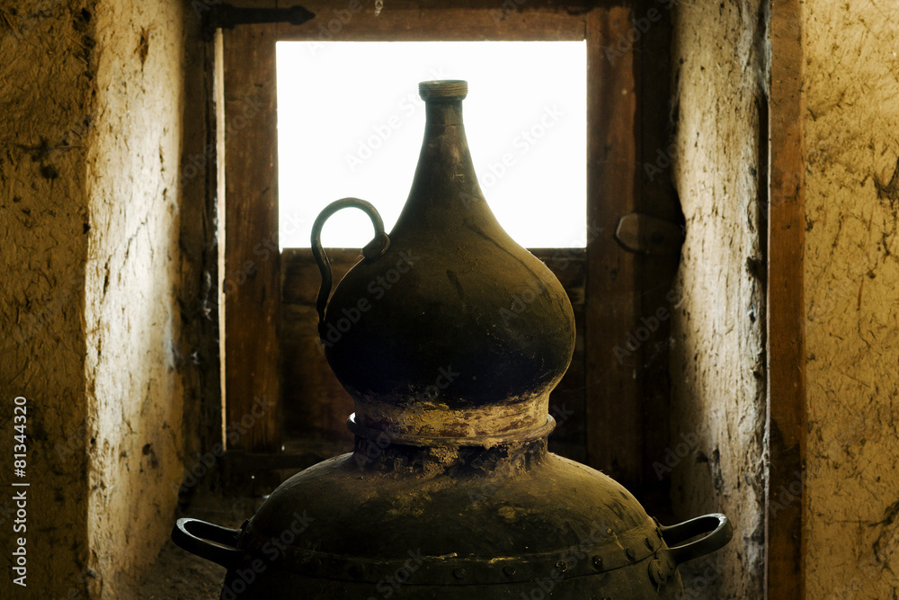 traditional alembic distiller with window in old adobe house traditional alembic distiller with window in old adobe house
