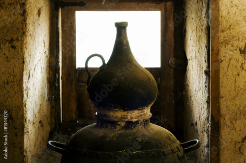 Konstfotografi traditional alembic distiller with window in old adobe  house