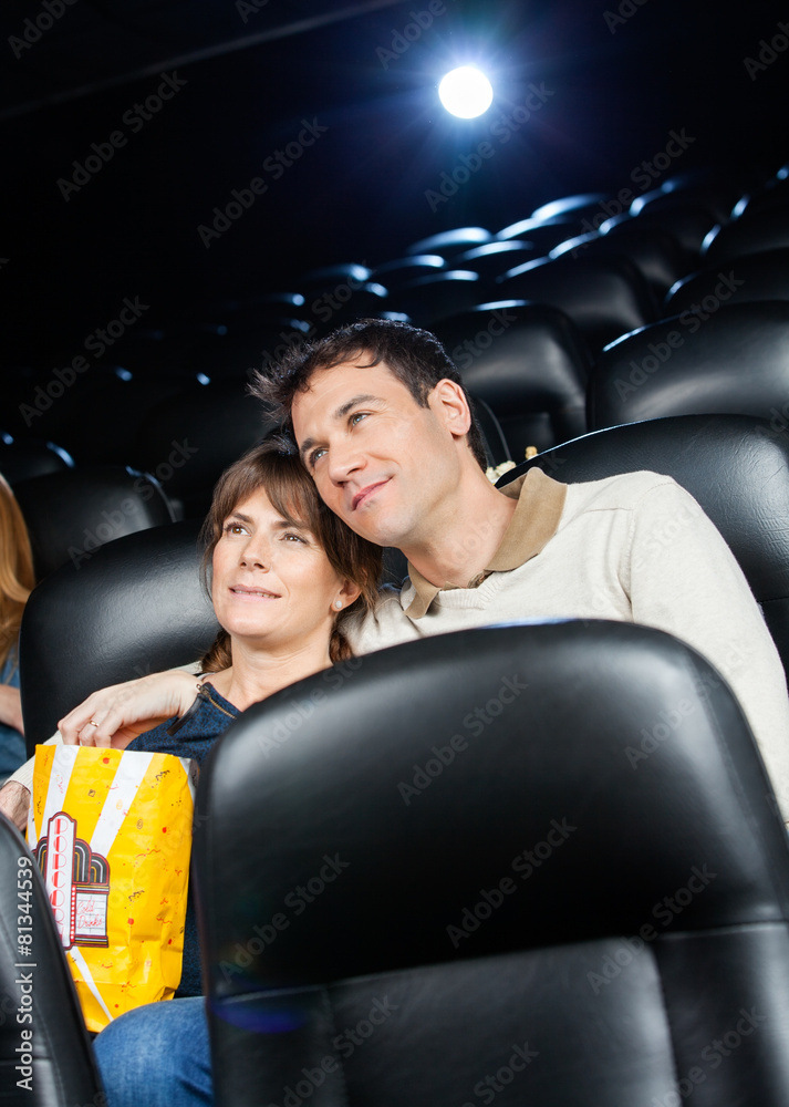 Naklejka premium Affectionate Couple Watching Film In Theater