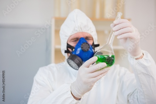 Bilde på lerret Scientist in protective suit examining green precipitate
