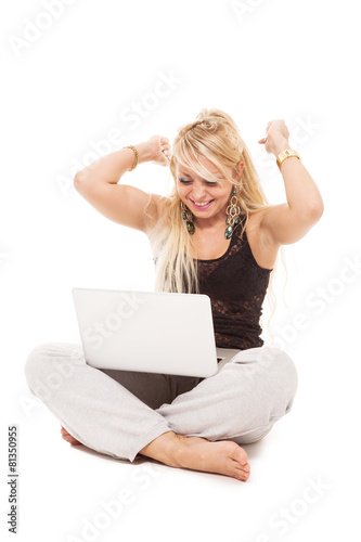 Happy blonde woman sitting on the floor with notebook over white © Francesco83