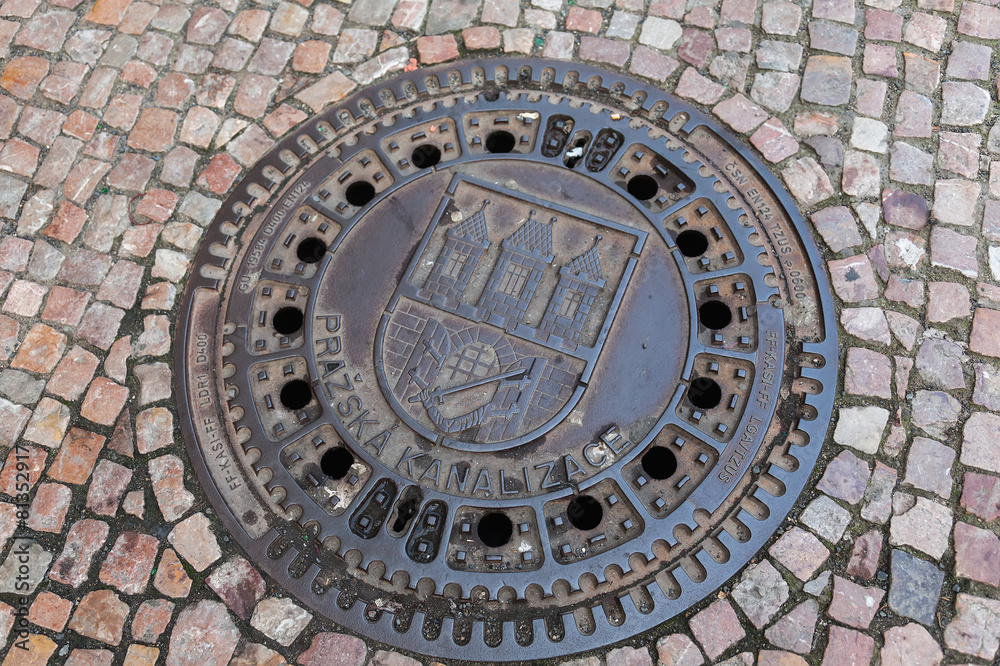 Manhole with the emblem of Prague in the historic city center