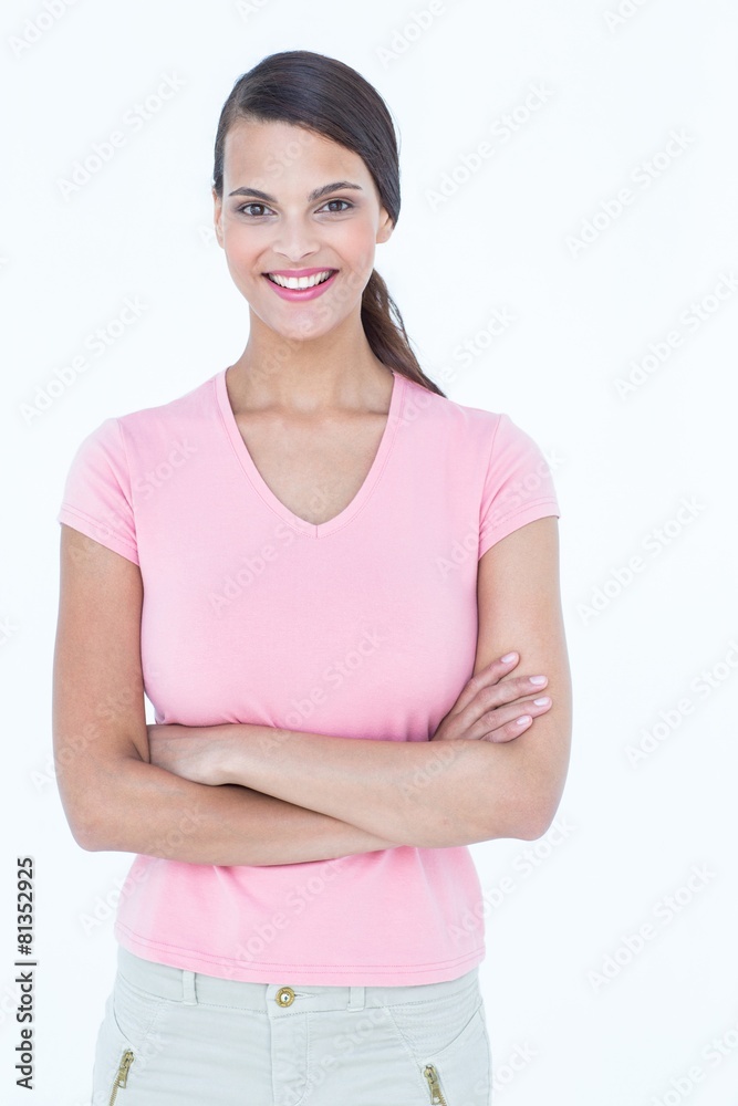 Happy brunette woman looking at camera with arms crossed Happy brunette woman looking at camera with arms crossed