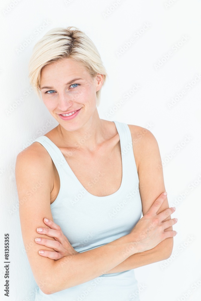 Happy woman smiling at camera with arms crossed Happy woman smiling at camera with arms crossed