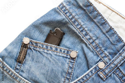 Blue denim background and cigarette lighter in pocket