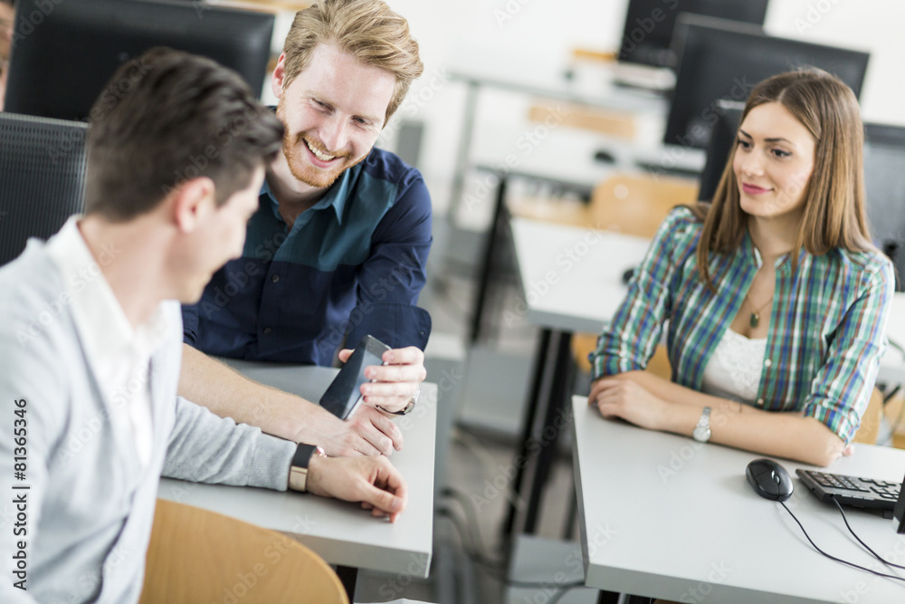 Young students talking in a classroom Young students talking in a classroom
