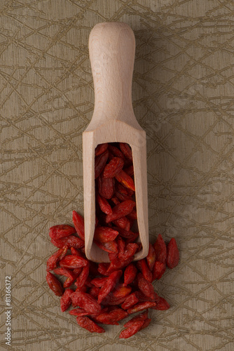 Wooden scoop with dry red goji berries