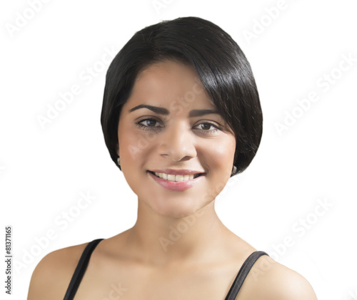 Young woman with short hair smiling over white background