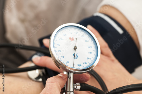 Female Doctor uses a sphygmomanometer
