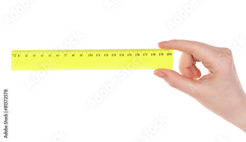 Female hand with plastic ruler isolated on white