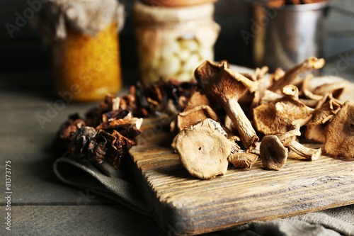 Fototapeta Dried mushrooms on cutting board, closeup