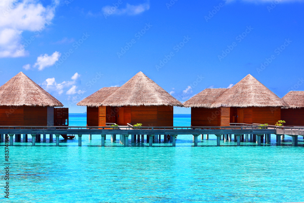 Water villas over blue ocean in Baros Maldives