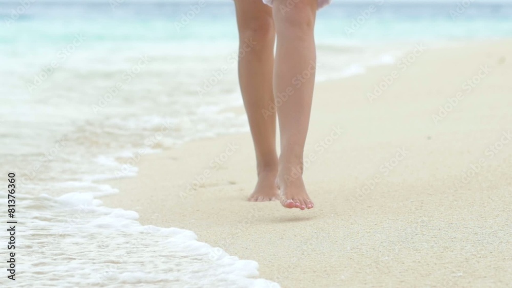 Legs of an beautiful woman walking on the sandy Maldives beach. Legs of an beautiful woman walking on the sandy Maldives beach.