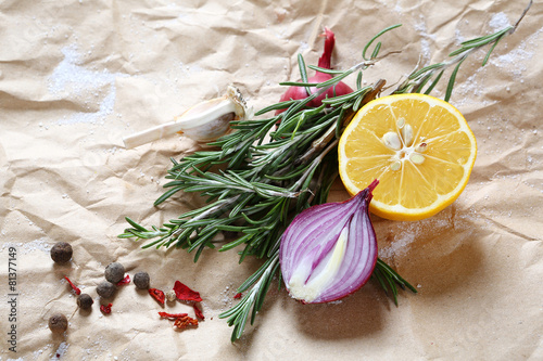 Fototapeta Naklejka Na Ścianę i Meble -  Onion, lemon and spices on paper