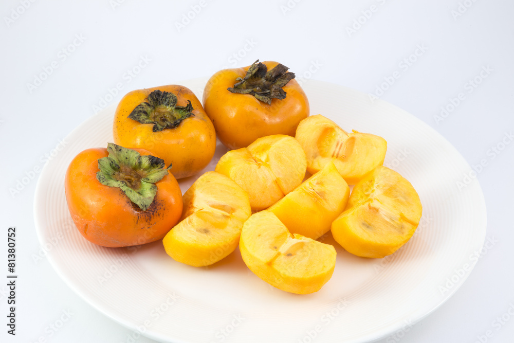 persimmon fruit on white dish