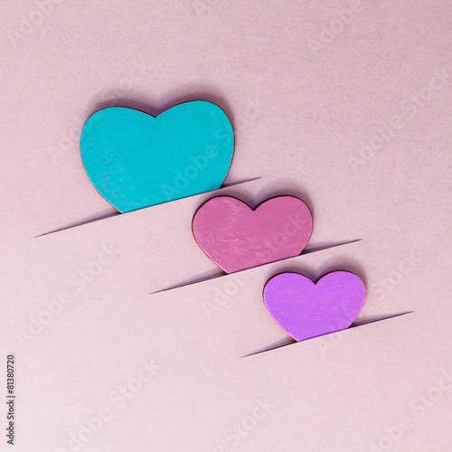 The wooden hearts on cardboard background. - Concept for love an