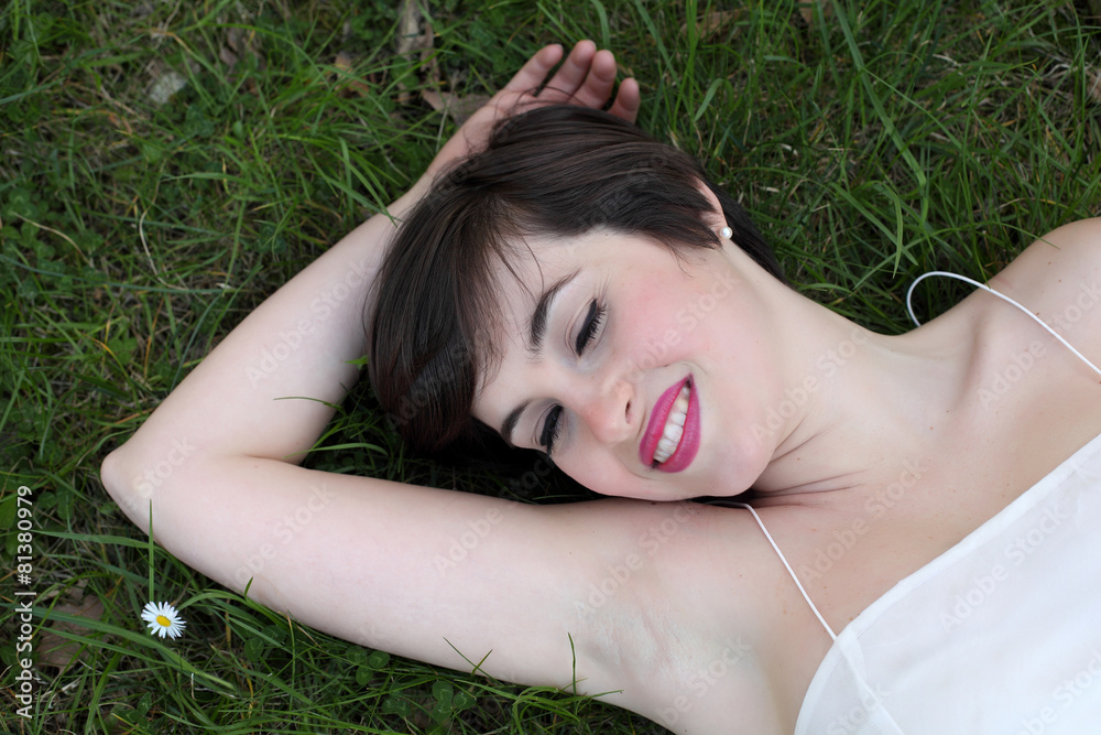 Smiling woman relaxing on the lawn