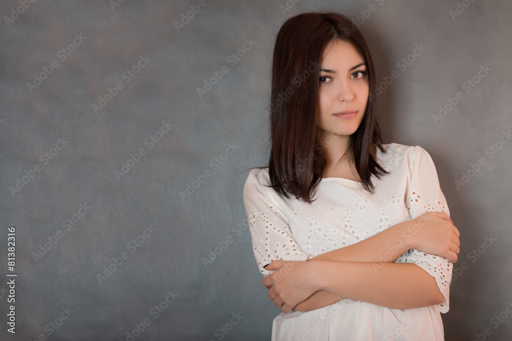 Happy beautiful woman in white dress on grey background. Happy beautiful woman in white dress on grey background.