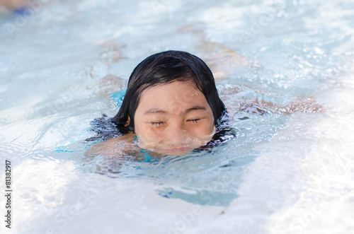Portrait of Asian girl swimming in swimming pool