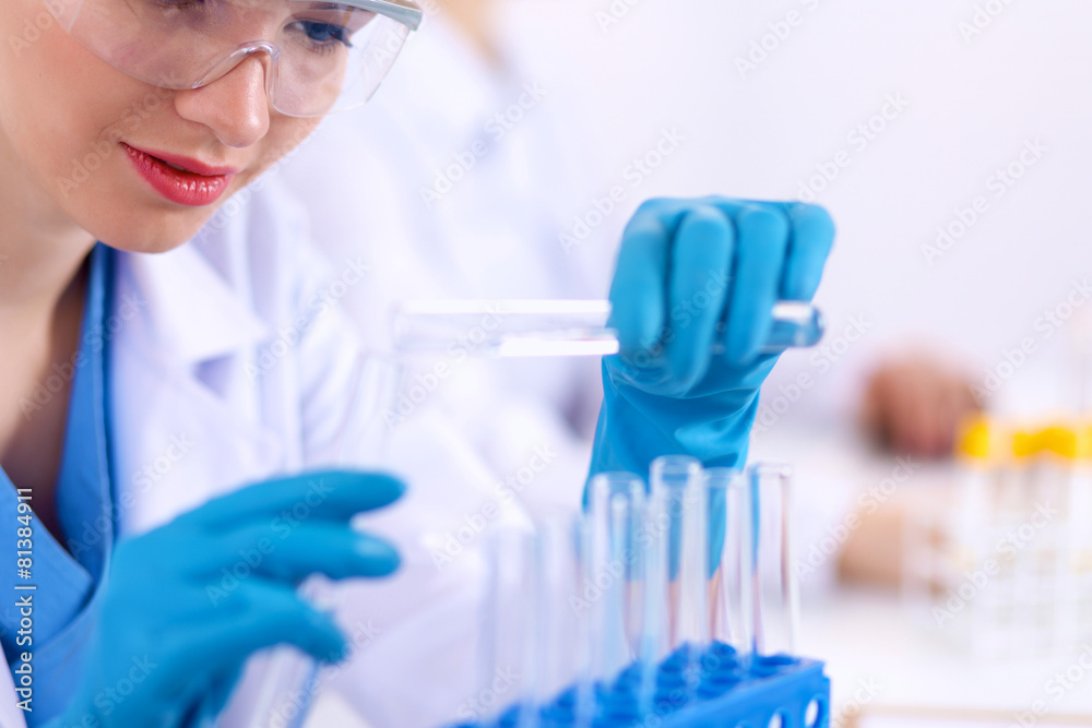 Woman researcher is surrounded by medical vials and flasks Woman researcher is surrounded by medical vials and flasks